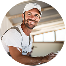 A maintenance worker wearing a white shirt and hat on a ladder