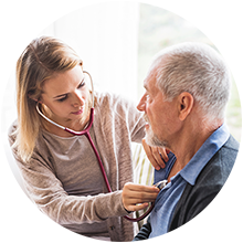 A caregiver checking the pulse of an elderly gentleman