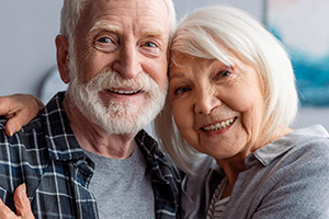 A senior man and a senior woman smiling