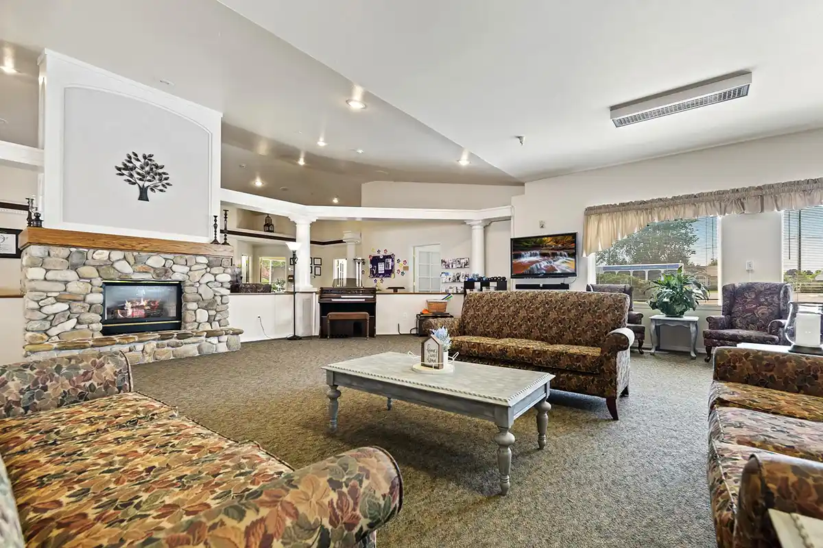 Living space with fireplace & couches at the Autumn Wind Assisted Living & Memory Care